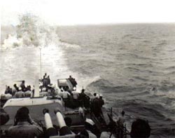 Photo of K-gun in action Photo of depth charge at 150 feet
